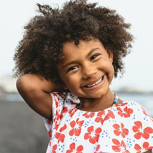 Child smiling at the beach.